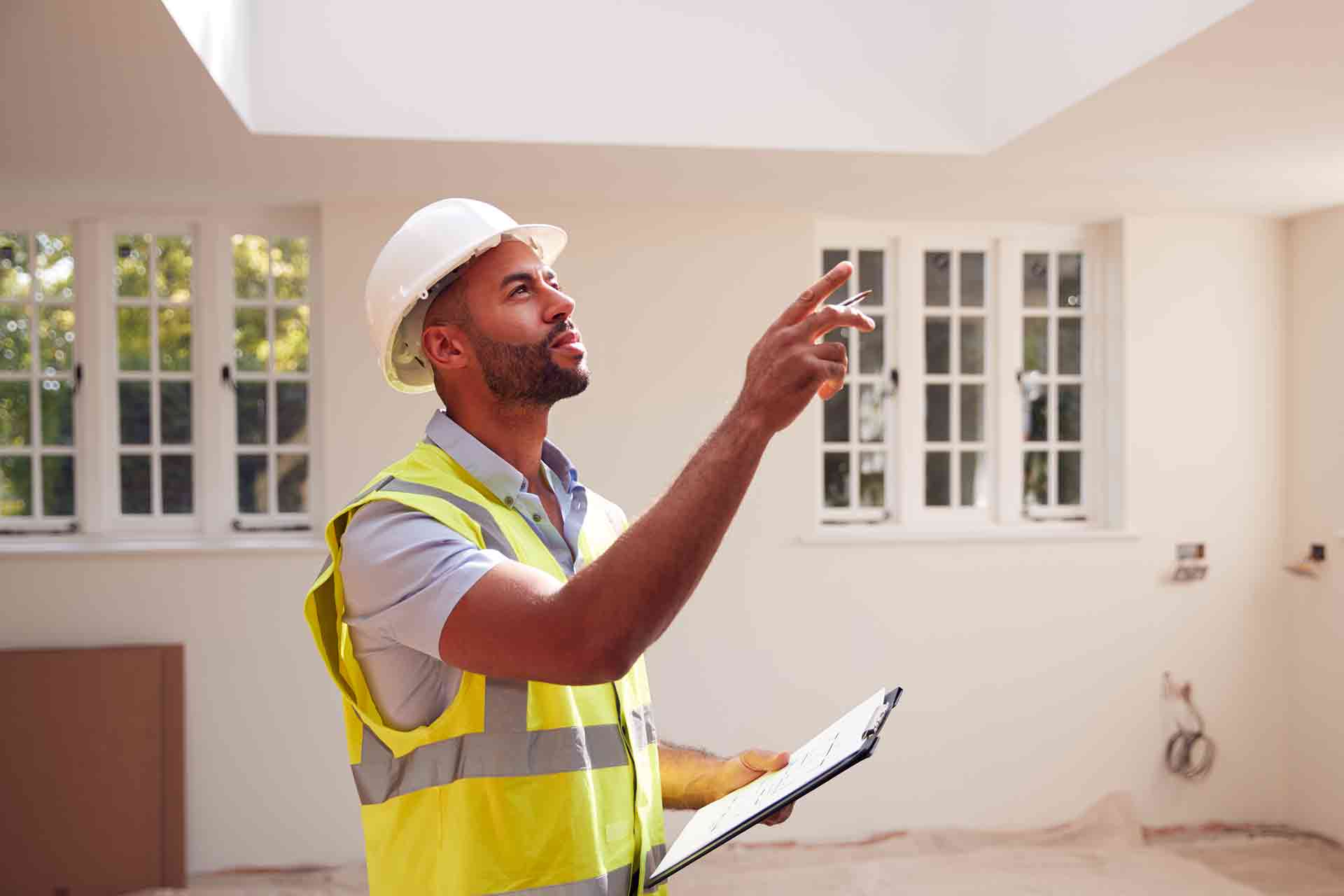 Third Party Wall Surveyors Slough reviewing plans between two parties during a dispute